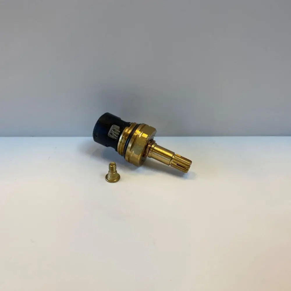 Ideal Standard Objekta-Kartusche in schwarzer und goldener Ausführung, bestehend aus einem zylindrischen Teil mit gewellter Griffoberfläche und einem kleinen Ansatz.